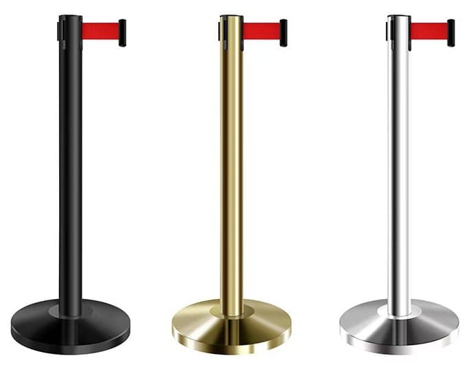 Three retractable belt barrier posts in black, gold and silver